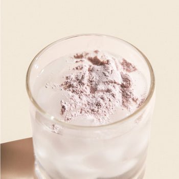 glass of water with powder on top