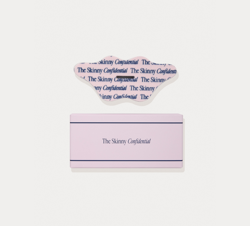 A pink rectangular box with a clear plastic lid, both printed with the text 'The Skinny Confidential', shown on a light gray background.